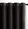 A close-up view of black curtains hanging from a curtain rod. Produktbild-Vorschau