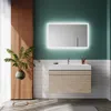 A modern bathroom with a vanity, sink, mirror, and plant. Produktbild-Vorschau