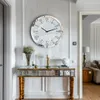 A hallway with a console table and a large wall clock. Podgląd zdjęcia produktu