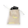 A beige drawstring bag containing a black power adapter and cable, shown against a white background. Produktbild-Vorschau