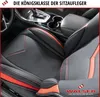 Close-up view of a car's front seat interior, focusing on a black and red seat cover. Produktbild-Vorschau
