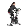 A woman is riding an indoor cycling bike. Produktbild-Vorschau