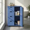 A blue bathroom cabinet with drawers and an open door, placed in a bathroom setting next to a bathtub. Produktbild-Vorschau