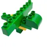 A close-up, slightly angled view of a green and yellow toy building block creation, resembling a stylized animal or vehicle, against a white background. Anteprima dell’immagine prodotto