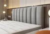 A close-up view of a mattress and headboard in a bedroom. Podgląd zdjęcia produktu