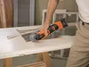 A person is using a power tool to cut a piece of wood on a door. Produktbild-Vorschau