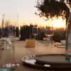 A table set for dinner outdoors at sunset, with a small aroma diffuser in the center. Produktbild-Vorschau