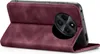 A close-up view of a burgundy flip case for a smartphone, showing the camera cutout and the case in an open position. Produktbild-Vorschau