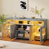 A modern gray sideboard with LED lighting, displaying various decorative items and books. Produktbild-Vorschau