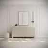 A minimalist bedroom or living room scene featuring a dresser, artwork, and a stool. Voir les images du produit