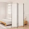 A white room divider is set up in a bedroom next to a bed and a nightstand with a lamp. Podgląd zdjęcia produktu