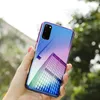 A hand holding a smartphone with a colorful, reflective case, with trees and buildings in the background. Produktbild-Vorschau