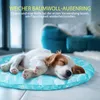 A puppy sleeping on a blue patterned mat in a living room. Produktbild-Vorschau