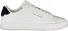 A white Tommy Hilfiger sneaker is shown from the side against a white background. Voir les images du produit