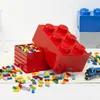 A collection of LEGO storage bricks and loose LEGO bricks are scattered on a rug. Voir les images du produit