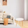 A living room scene with a couch, a small round table, and artwork on the wall. Produktbild-Vorschau