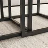 Close-up of the black metal frame of a coffee table set on a textured rug. Podgląd zdjęcia produktu