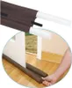 A hand is shown placing a draft stopper under a door to prevent drafts. Anteprima dell’immagine prodotto