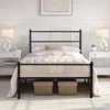 A black metal bed frame with a mattress and bedding is shown in a bedroom setting. Voir les images du produit