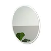 A round mirror with a white frame is shown against a white background. A green leaf is reflected in the mirror. Produktbild-Vorschau