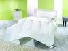 A white duvet and pillow are neatly arranged on a bed in a room with bright green walls. Produktbild-Vorschau
