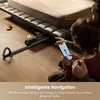 A person is using a smartphone to control a robotic vacuum cleaner under a bed. Produktbild-Vorschau