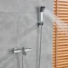 A shower faucet and handheld showerhead are mounted on a gray tiled wall. Náhľad obrázku produktu