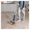 A person is using a wet dry vacuum cleaner to clean up a spill on a wooden floor in a kitchen. Produktbild-Vorschau