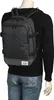 A person wearing a dark sweater and jeans is shown from the back, wearing a dark gray backpack. Podgląd zdjęcia produktu