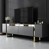A modern TV stand with a television on top, displayed in a dimly lit room. Anteprima dell’immagine prodotto