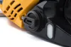 A close-up view of a yellow and black chainsaw, focusing on the fuel cap and oil reservoir. Produktbild-Vorschau