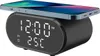 A black digital alarm clock with a wireless charging pad on top, charging a smartphone. The clock displays the time and temperature. Produktbild-Vorschau