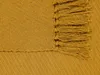 A close-up view of a mustard yellow blanket with fringe. Produktbild-Vorschau
