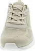 A close-up front view of a beige sneaker. Voir les images du produit