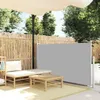 An outdoor patio scene with a retractable side awning, lounge chair, and coffee table. Produktbild-Vorschau
