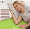 A woman sleeping on a bed with a green sheet and a striped pillow. There are three oval-shaped text boxes on the left side of the image. Produktbild-Vorschau