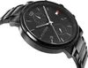 A close-up, angled shot of a black Tommy Hilfiger watch against a white background. Náhled obrázku produktu