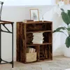 A wooden bookshelf with books and a basket on it, next to a desk and a plant. Produktbild-Vorschau