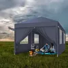 A couple sits inside a grey party tent in a grassy field, with a campfire burning nearby. Náhled obrázku produktu