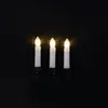Three white LED candle lights with yellow flames on a black background. Produktbild-Vorschau
