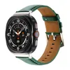 A smartwatch with a green leather band is shown against a white background. Náhled obrázku produktu