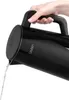 A hand is holding a black electric kettle as water is being poured out. Anteprima dell’immagine prodotto
