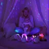 A woman and a baby are sitting in a tent-like structure with projected stars on the fabric. Several plush toys are arranged in front of them. Anteprima dell’immagine prodotto