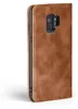 A brown leather flip case for a smartphone, shown from the side with the camera module visible. Produktbild-Vorschau