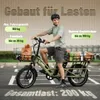 A man is riding an olive green electric cargo bike loaded with groceries and bread. Produktbild-Vorschau