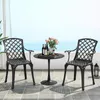 Two black cast aluminum chairs and a small black table with wine bottles and flowers on a patio overlooking the ocean. Podgląd zdjęcia produktu