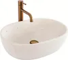 A white speckled basin with a bronze faucet against a white background. Produktbild-Vorschau