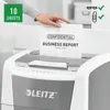 A person is feeding a document into a paper shredder. Voir les images du produit