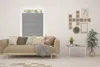 A living room scene with a sofa, window blinds, a coffee table, and wall decor. Produktbild-Vorschau