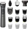 A collection of grooming tools and attachments, including a main trimmer unit, nose trimmer, and various comb attachments, laid out against a white background. Anteprima dell’immagine prodotto